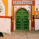 Colorful mosque entrance, cat, garbage in the street- a very typical scene to capture the essence of a Moroccan Medina. Oct. 20 2018.